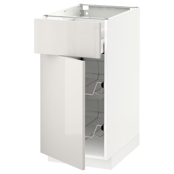 White high-gloss METOD kitchen unit with open drawer and shelves.