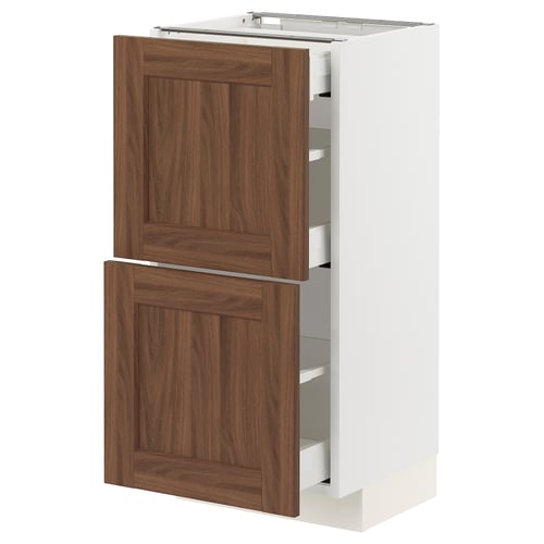 METOD kitchen cabinet in white, featuring walnut finish drawers. Modern design with wooden texture accents.