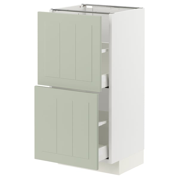 White and green kitchen cabinet with two drawers and two doors, modern design.