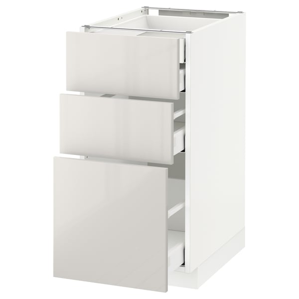 This image a white METOD kitchen cabinet with three open drawers. The cabinet is modern and sleek, with a smooth, glossy finish.