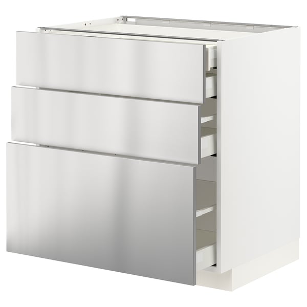 A white METOD kitchen cabinet with stainless-steel drawers. The modern design includes three large drawers with a sleek, industrial aesthetic.