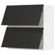 Modern black kitchen cabinet with two doors. Sleek, rectangular design. White frame and smooth black doors.