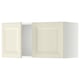 Two white METOD kitchen wall cabinets with bevelled doors.
