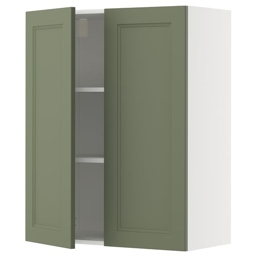 Green kitchen cabinet with one door open, showing adjustable shelf.