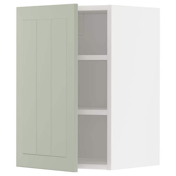 A green METOD kitchen cabinet with a shaker-style door and adjustable shelves.