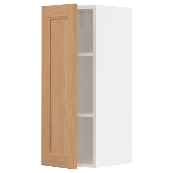 An open METOD kitchen cabinet with a wooden door in a light oak colour.