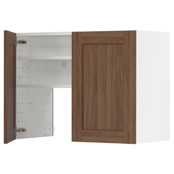 A wooden METOD kitchen cabinet with an open door revealing white shelves. It a walnut finish, adjustable shelves, and a modern design.