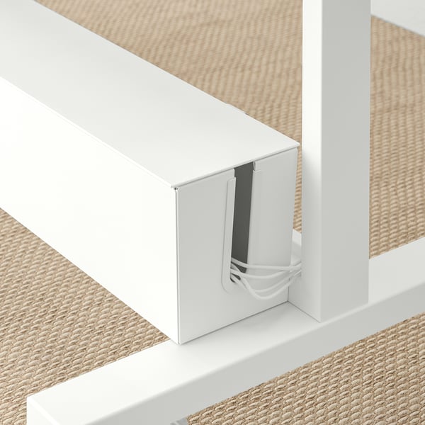 White freestanding room divider with plant containers, cord management system, and lockable castors.