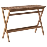 A brown NÄMMARÖ folding wooden outdoor table with a rectangular top and x-shaped legs.