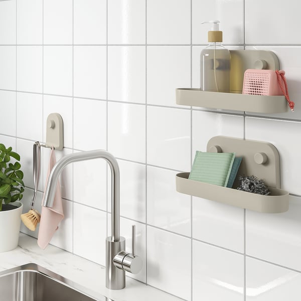 Modern kitchen with ÖBONÄS: drill-free, wall-mounted shelves using suction cups. Holds items near tap, freeing counter space.