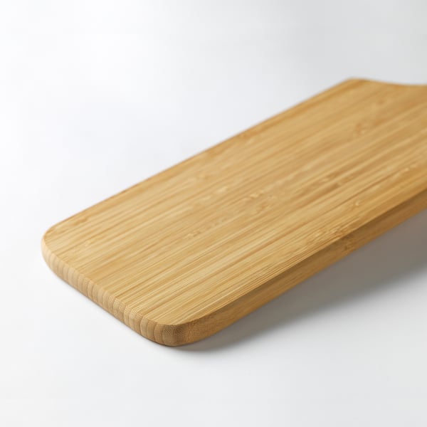 Smooth, rectangular bamboo cutting board on a white surface.
