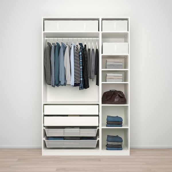 White PAX wardrobe displaying clothes on hangers, folded clothes on shelves, and neatly organised accessories in baskets.