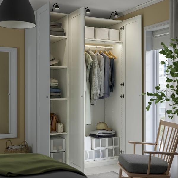 Modern closet with open doors, displaying clothes and accessories.