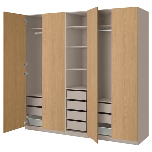 A wooden PAX wardrobe with open doors displaying shelves, drawers, and compartments.
