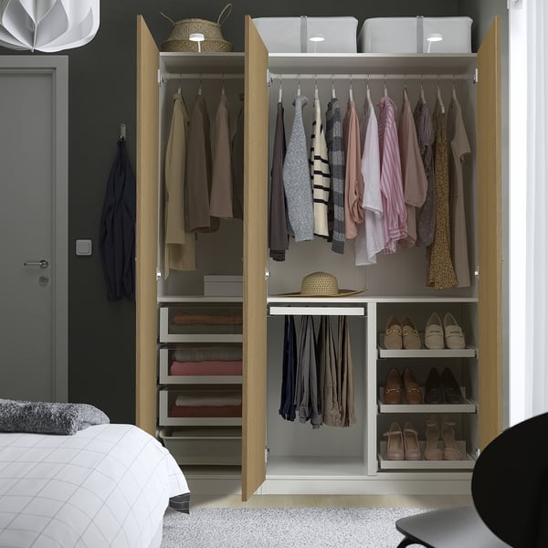 Open wardrobe with clothes and storage, organised bedroom space.