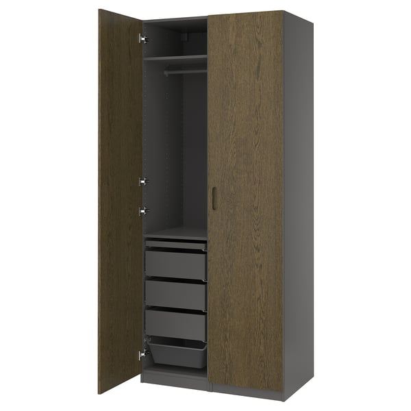 A PAX wardrobe, a classic closet with wooden doors and multiple drawers. Its designed for organising clothes efficiently.