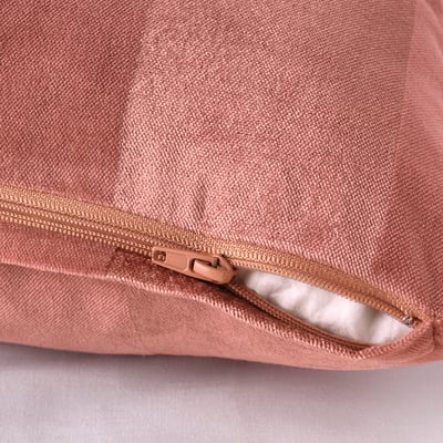 Hidden zip on pink cushion cover, easy to remove, fits 50x50 cm cushion.