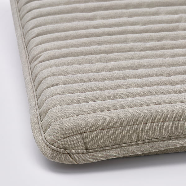 Close-up of POÄNG fabric cushion, showing its soft, pleated texture and quality craftsmanship.