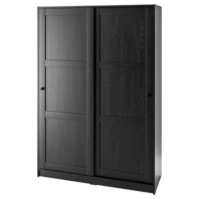 A black RAKKESTAD wardrobe with sliding doors. It has a sleek, rectangular design with dark wood finish.