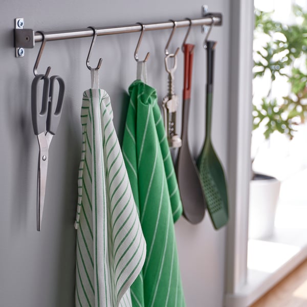 Towels and scissors hang from hooks, showing kitchen organiser tools.