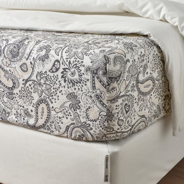 Paisley-patterned flat sheet on bed; zip visible, indicating easy-fit feature.