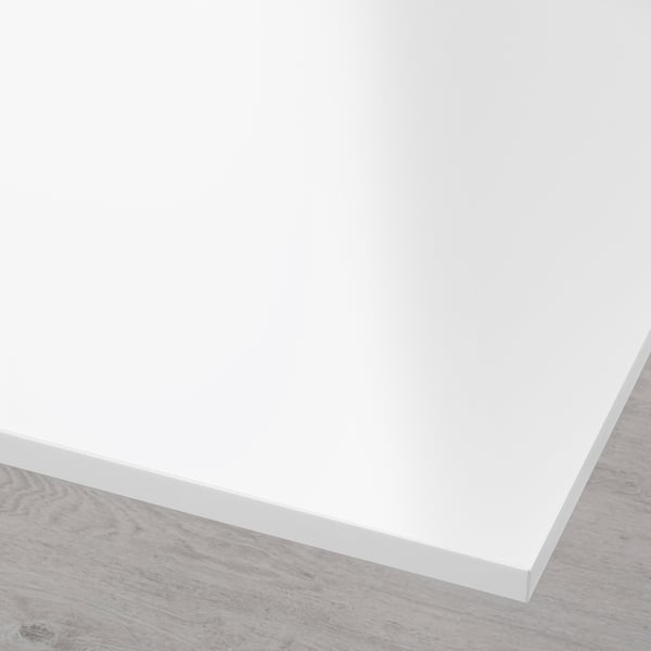Modern, white, minimalist tabletop with sleek edges on wooden floor.