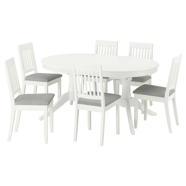 White ROSENTORP dining set: oval table, 6 chairs. Chairs have grey cushions, wooden backs. Table extends for more seating.