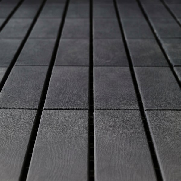 Dark grey decking panels, neatly aligned and evenly spaced, showcasing smooth, uniform texture, indicative of high-quality, durable material.