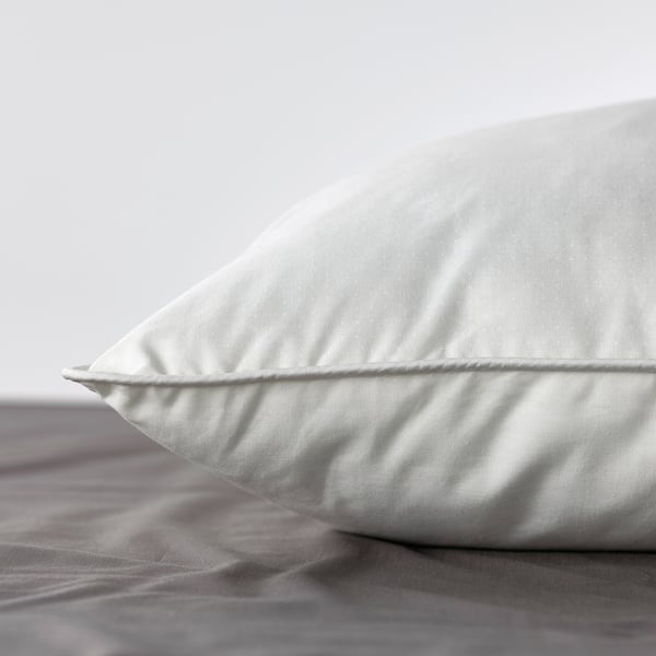 Soft, plump pillow on bed, showcasing quality materials for comfort.