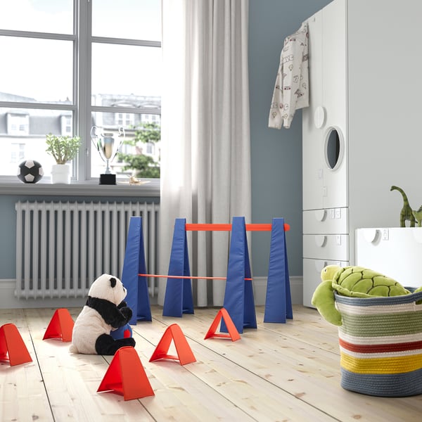 Indoor obstacle course with cones and panda toy.