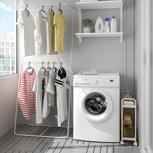 Small white SLIBB drying rack holds clothes neatly. Fits tight spaces, dries gently.