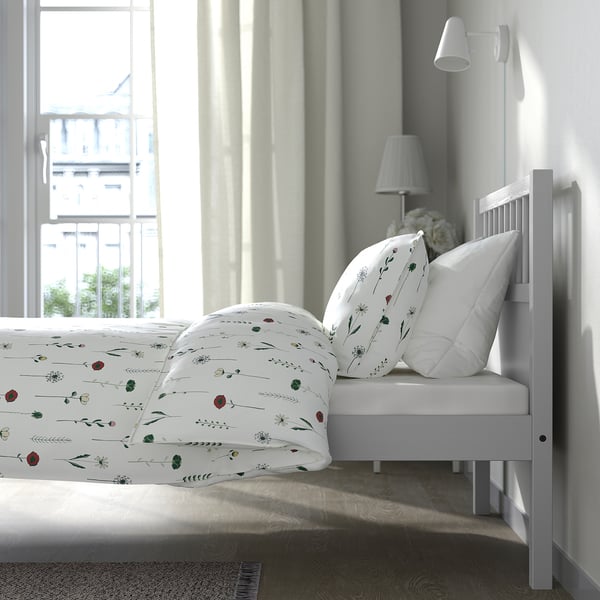 Bedroom: white bed, florals, lamps, large window