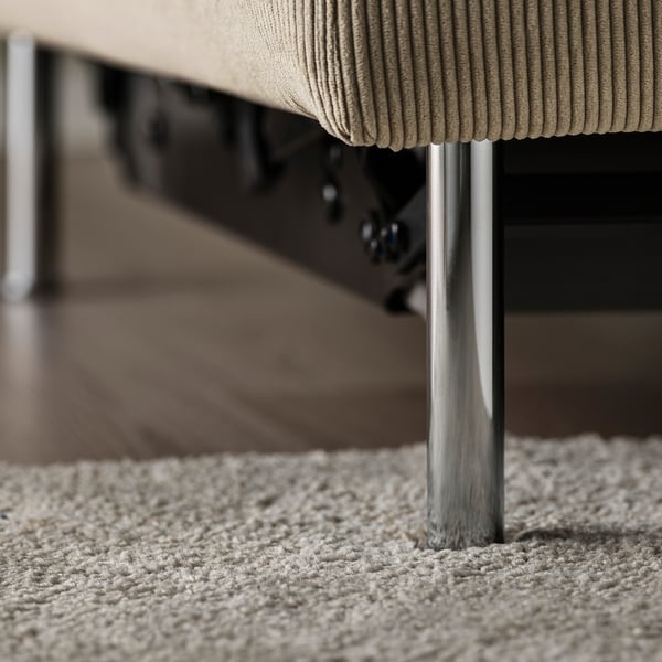 Close-up of a modern sofa beds cushioned seat and metal legs, showcasing its sleek design and comfort.
