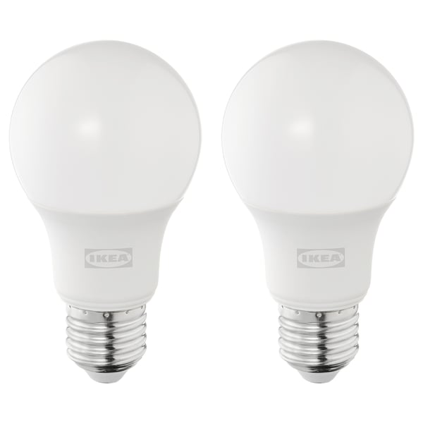 Two ikea led bulbs, white, round shape, silver base, stand upright, brand visible.