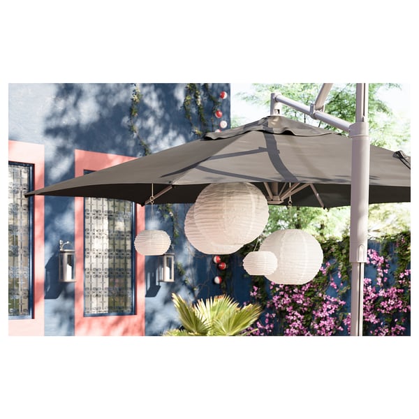 SOLVINDEN solar lamps on umbrella with glowing lights.