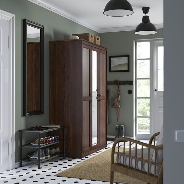 Stylish entry with SONGESAND wardrobe, shoe rack, bench, chequered floor, and natural light.