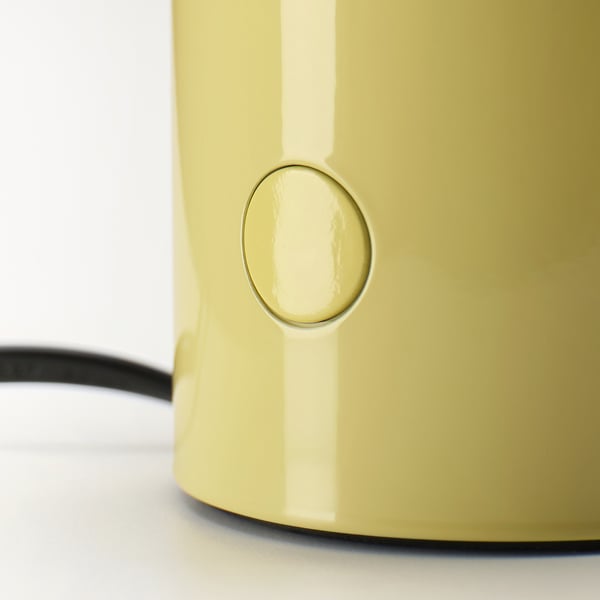 A yellow table lamp with a sleek design and a small button on the side for control.