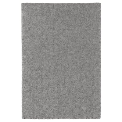A grey rectangular STOENSE rug with a soft, textured surface, perfect for adding comfort and style to rooms.