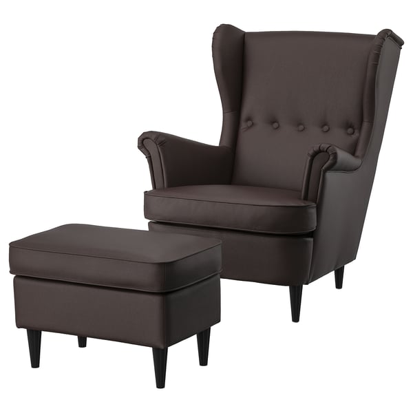 Dark brown wingback chair with matching ottoman, leather upholstery, high back, armrests, and tapered legs.