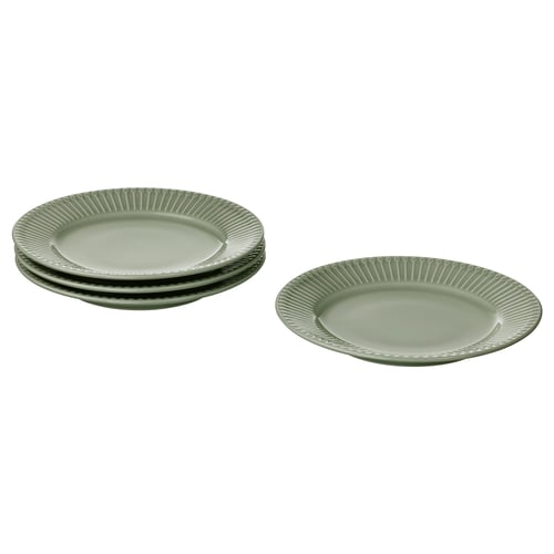 Four light green plates, three stacked, one flat, textured rim, ceramic.