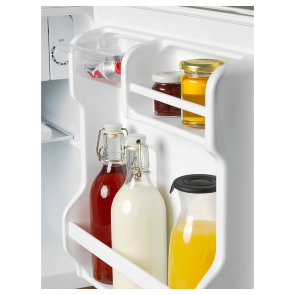Small fridges chill compartment holds various beverages and condiments, indicating its function to keep items cold.