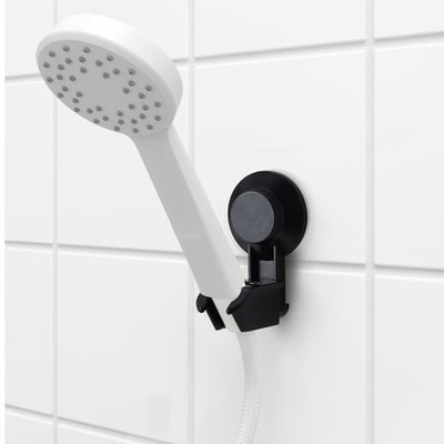TISKEN white handheld shower head with black suction cup bracket. Adjustable and compact.
