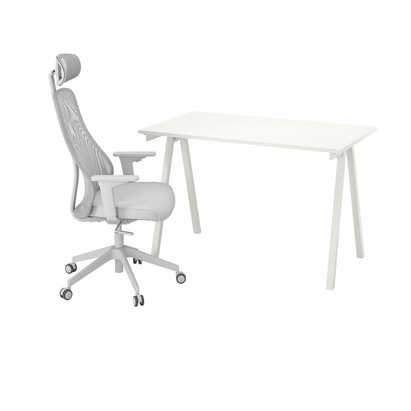 White desk and ergonomic office chair with mesh back and adjustable armrests.