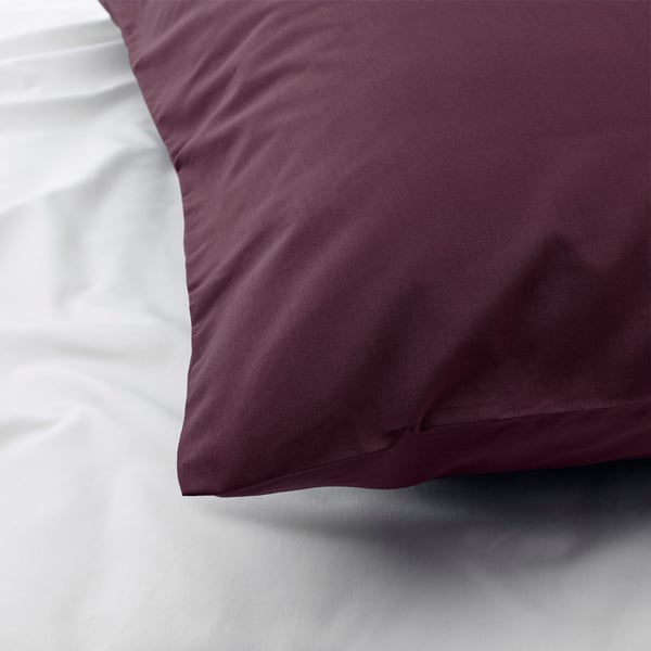 Close-up of burgundy pillowcase with crisp, soft texture on white bedding, showcasing high-quality cotton and lyocell blend.