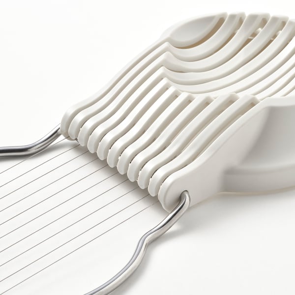 Close-up of egg slice tool, sleek design, durable plastic and stainless steel.