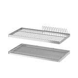 Two silver metal UTRUSTA dish drainers, one with a wire rack and one with a grid tray, designed for wall cabinet mounting.