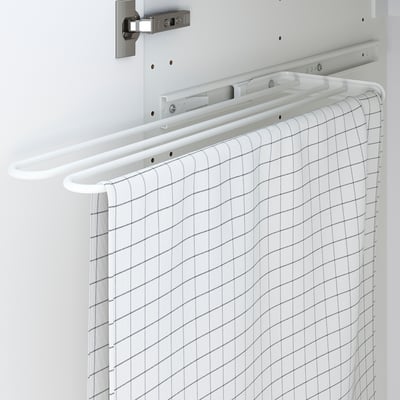 Cabinet with built-in towel rack, pulls out for easy access.