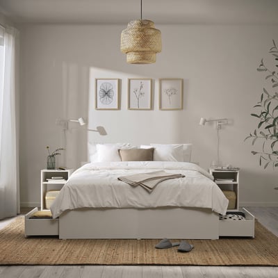 A modern, cosy bedroom with a light VIHALS bed, four storage boxes, white linens, matching nightstands, three wall arts, and a pendant light.