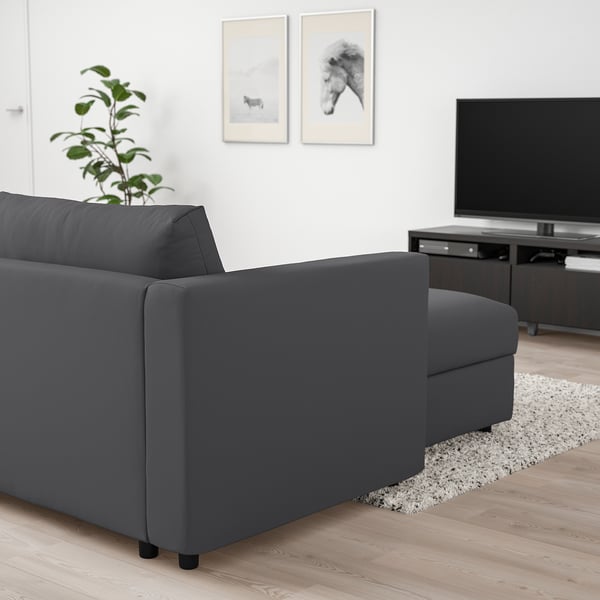 Grey VIMLE sofa with chaise, supportive cushions, next to large tv and plant.