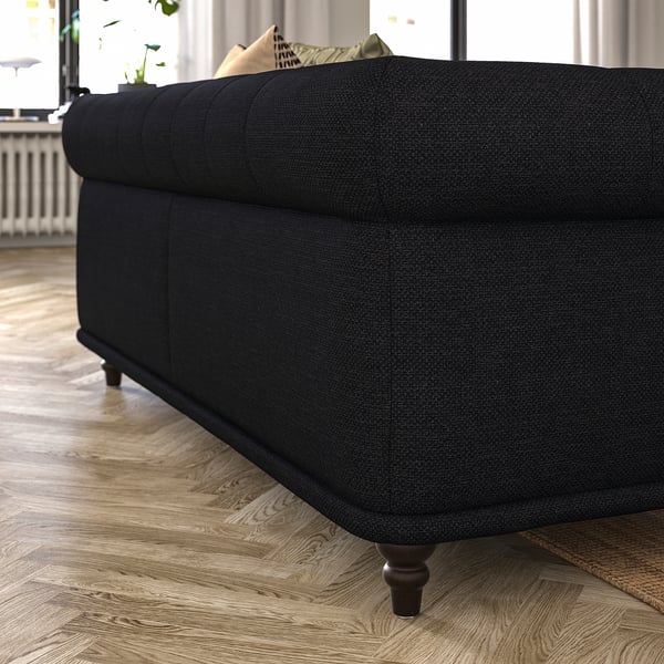 Black VISKAFORS sofa, classic design with soft curves, dark fabric, wooden legs, plush cushions.